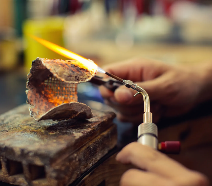 Craftsperson working with a blowtorch