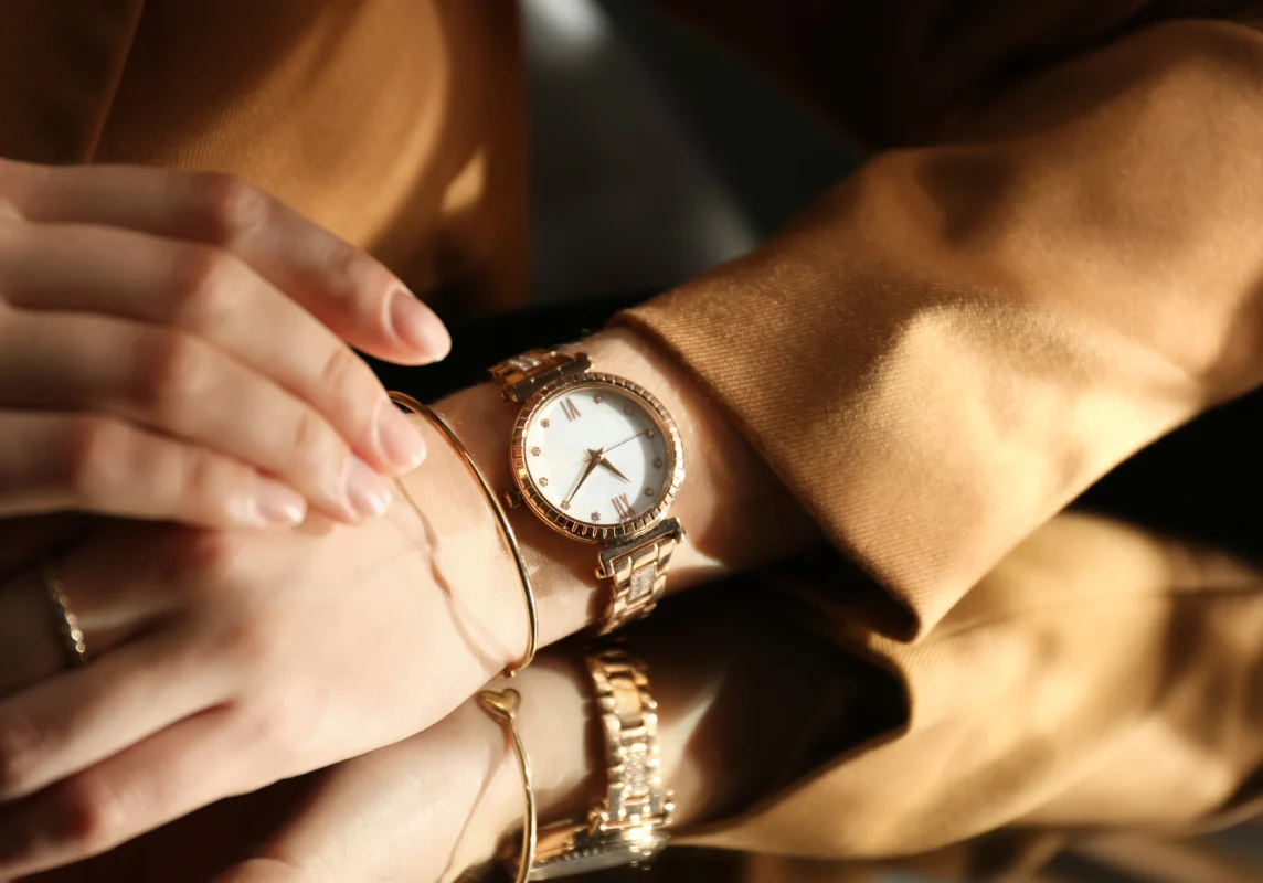 Elegant gold watch on woman's wrist